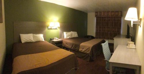 a hotel room with two beds in a room at Rodeway Inn in Moriarty