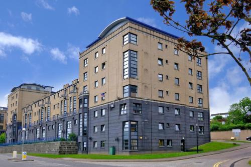 un grand bâtiment en briques au coin d'une rue dans l'établissement Riverside Lodge - Grampian Lettings Ltd, à Aberdeen