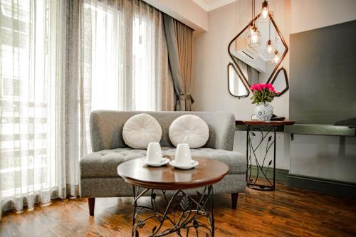 a living room with a couch and a table at Hanoi Center Silk Hotel & Travel in Hanoi