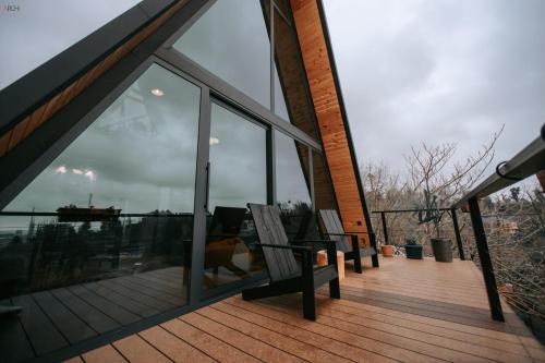 a house with a balcony with a view of the water at Hilltop Batumi in Batumi