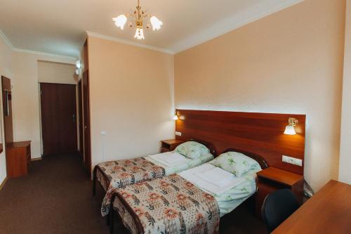 a hotel room with a bed and a table at Hotel Mashuk in Pyatigorsk