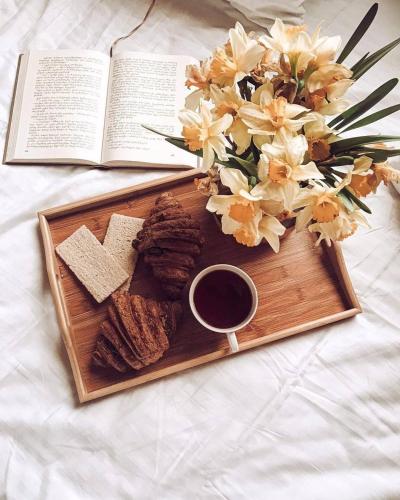a plate of food with a book and a cup of coffee at Hilltop Batumi in Batumi