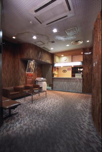 a waiting room with couches and chairs in a building at ホテルアークインてんねん in Nagasaki