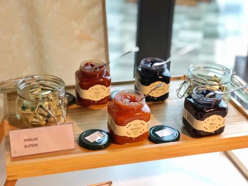 a shelf with several jars of honey on it at 16 Lakes Hotel in Grabovac