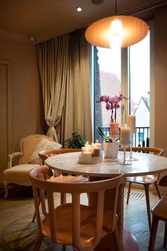 a dining room with a table with candles on it at Redstone Apartments in Rīga