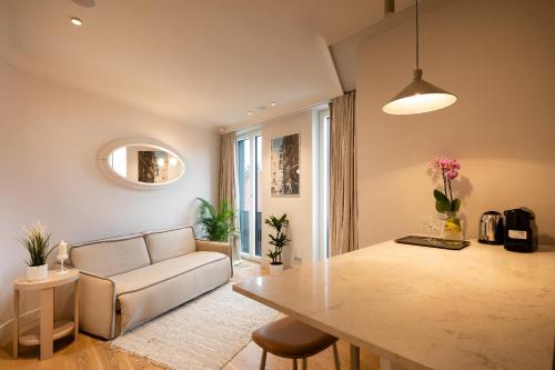 a living room with a couch and a table at Redstone Apartments in Rīga