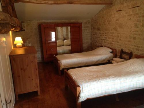 a bedroom with two beds and a mirror in it at Columba - Les Constellations in Doeuil-sur-le-Mignon