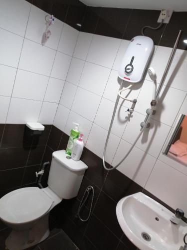 a bathroom with a toilet and a sink at StarVilla Kinta River Front Medan Istana in Ipoh