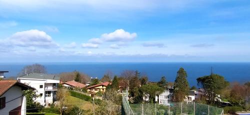 a view of the ocean from a city at IGELDO HOUSE in Donostia-San Sebastián