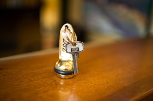 a small metal key sitting on top of a table at Rex Hotel Residence in Genova