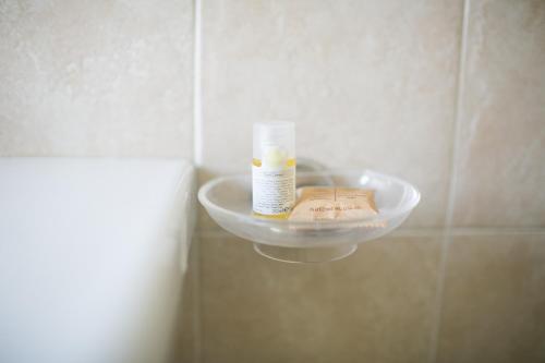 a bathroom with a soap dispenser on a wall at Rex Hotel Residence in Genova