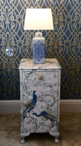 a lamp on top of a dresser with a blue and white dresser at The Kings Head Inn in Billingshurst