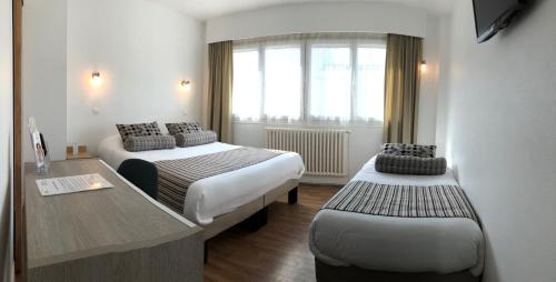 Ένα ή περισσότερα κρεβάτια σε δωμάτιο στο Cit'Hotel Atlantis