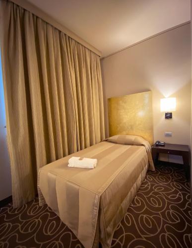 Postel nebo postele na pokoji v ubytování Hotel Riviera
