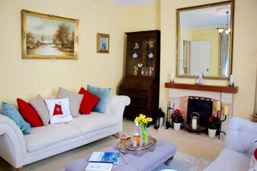 a living room with two couches and a fireplace at Seaside Luxury House on the Suffolk Coast in Saxmundham