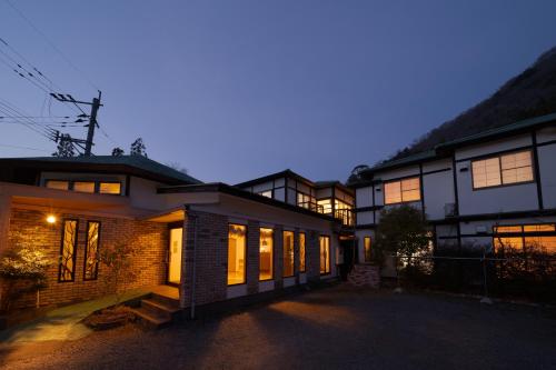a building with a lot of windows in the evening at David no Yakata in Yufu
