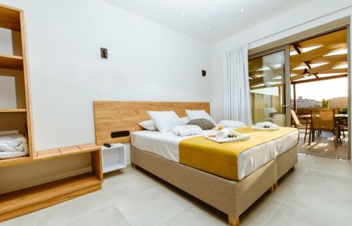 a bedroom with a large bed and a balcony at Iliovasilema Apartments in Elafonisi