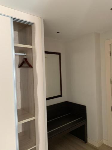 a dressing room with a mirror and a closet at Hotel Villegas in Valencia de Don Juan