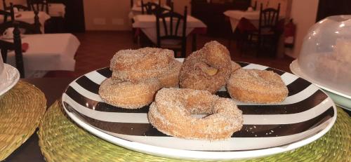 a plate of donuts sitting on a table at Hotel Rural Posada Los Caballeros in Almagro