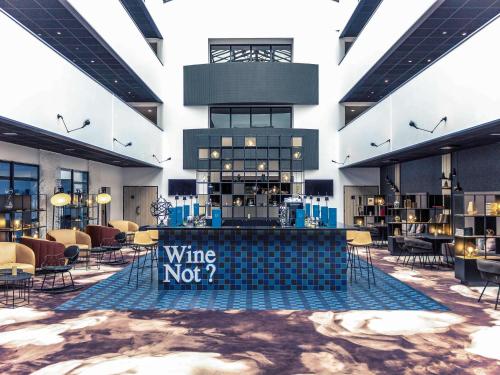 a restaurant with a wine not sign in the middle of a building at Hotel Mercure Blois Centre in Blois