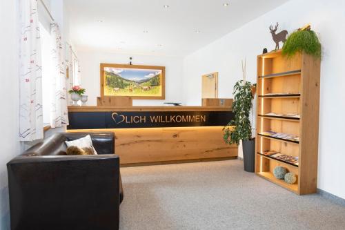 a lobby with a desk and a couch in a room at Sun Valley - Wildschönau in Auffach