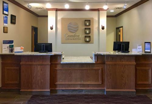 a hotel room with a desk and a large mirror at Comfort Inn & Suites Near Custer State Park and Mt Rushmore in Custer