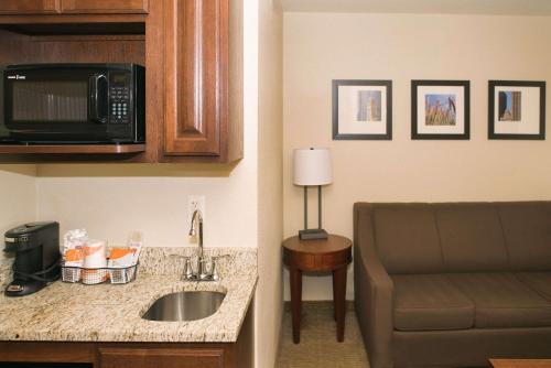 a hotel room with a sink and a microwave at Comfort Inn & Suites in Custer