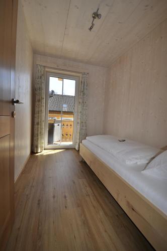 a small bedroom with a bed and a window at Ferienwohnungen Holzidylle in St. Wolfgang