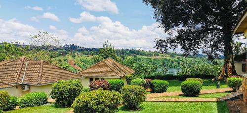 a house with a garden with bushes and trees at Jinja Nile Resort in Jinja