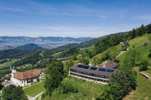 an aerial view of a house with solar panels on a hill at Hotel Viktor in Viktorsberg