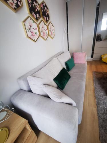 a living room with a couch with pillows on it at Greta in Świnoujście