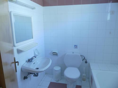 a white bathroom with a toilet and a sink at Marianthi Studios & Apartments in Pefki Rhodes