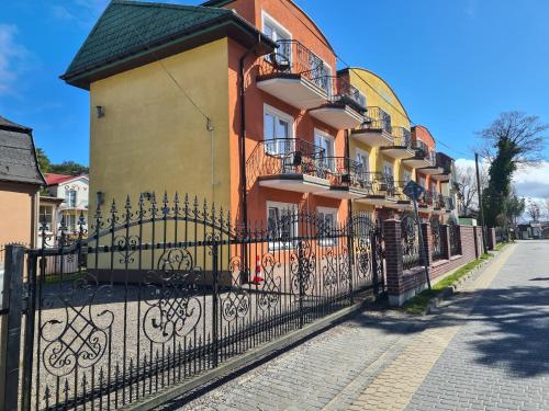 a black fence in front of a building at Willa u Anny in Mielno