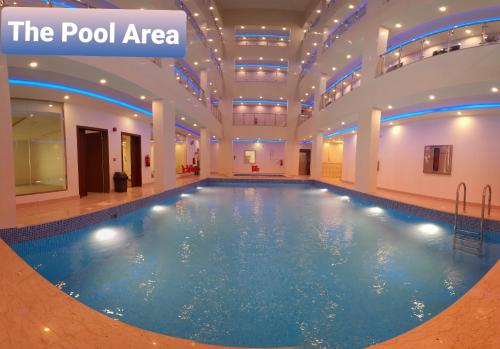 a swimming pool in a building with a pool area at Villa Park in Al Khobar