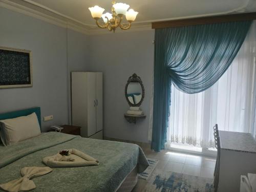 a bedroom with a bed and a mirror and a window at EPHESUS CENTRUM in Selcuk