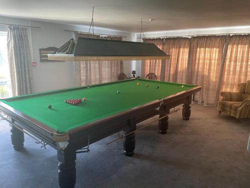 a pool table with balls on it in a living room at Moorhead Country Holidays in Bideford