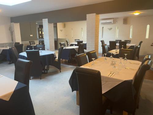 a dining room with tables and chairs and tablesktop at Moorhead Country Holidays in Bideford