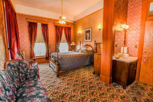 a hotel room with a bed and a couch at Irma Hotel in Cody