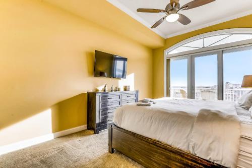 a bedroom with a bed and a tv and a window at South Beach in Ocean City