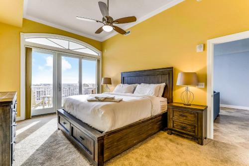 a bedroom with a large bed with a ceiling fan at South Beach in Ocean City