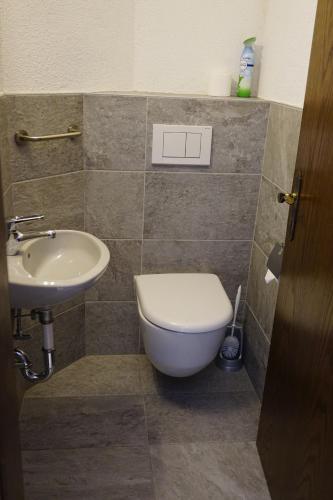 a bathroom with a toilet and a sink at Aristella in Saas-Almagell