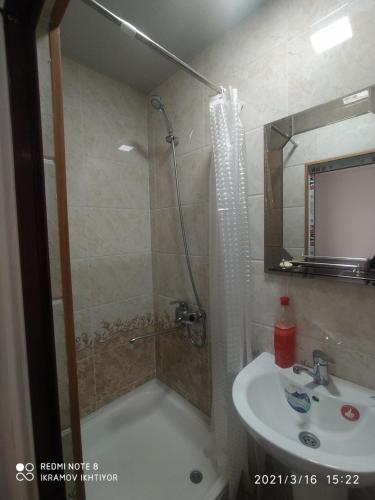a bathroom with a shower and a sink at Minorai Xurd in Bukhara