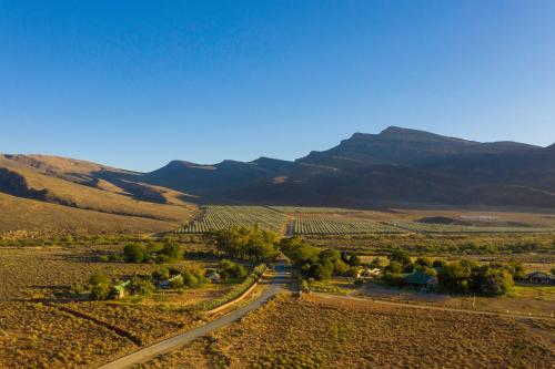 an aerial view of a road in a valley with mountains at Mount Ceder in Cederberg