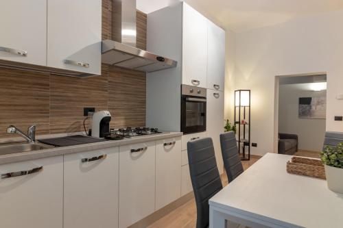 a kitchen with white cabinets and a counter top at Residenza San Leonardo - Viterbo Centro Storico in Viterbo