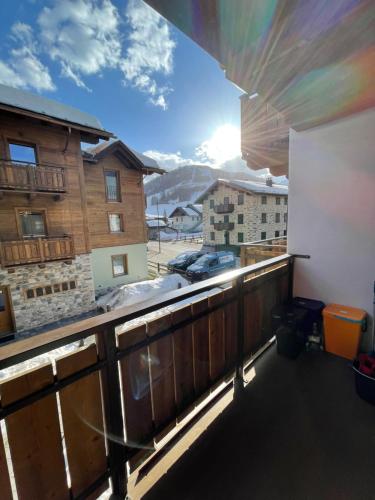 a balcony with a view of a snow covered mountain at Chalet Lilla Livigno in Livigno