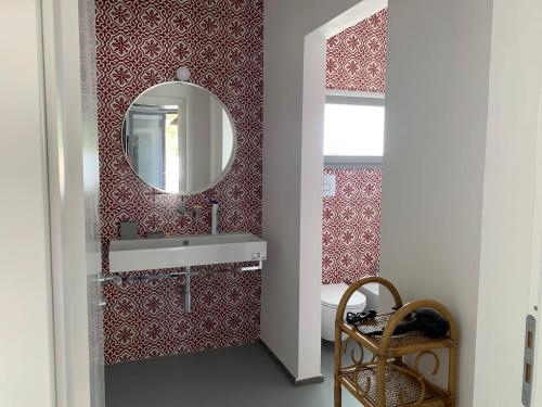 a bathroom with a sink and a mirror at Le Casuzze Ammare in Favignana