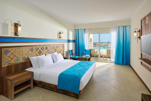 a bedroom with a bed and a view of the ocean at Lazuli Hotel, Marsa Alam in Quseir