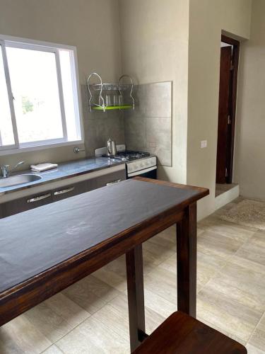 a kitchen with a table and a sink and a stove at MORTERO II in Cafayate
