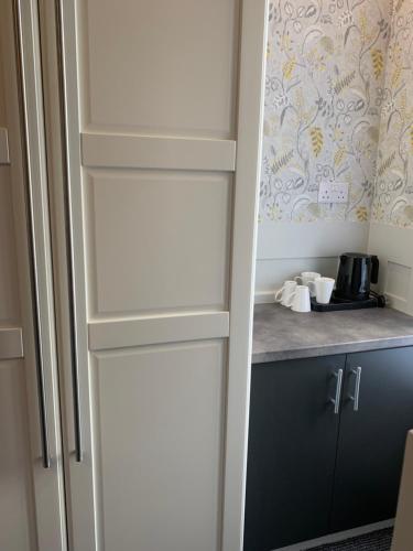 a cupboard in a kitchen with a counter top at The Woodleigh family hotel in Blackpool