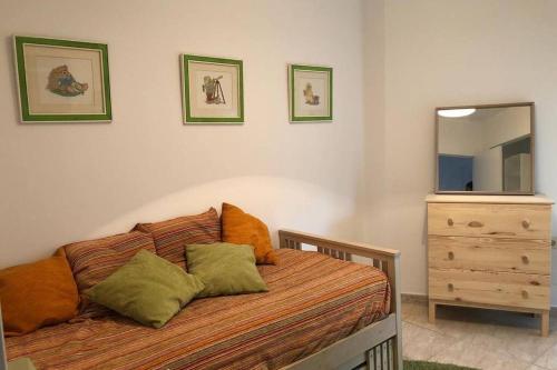 a bedroom with a bed and a dresser and a mirror at Casa en plena naturaleza al lado del rio Verdugo in Arcade